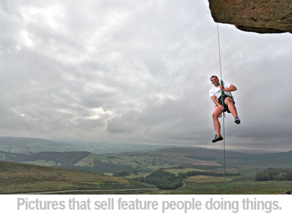 an example of a man smiling on a climbing rope
